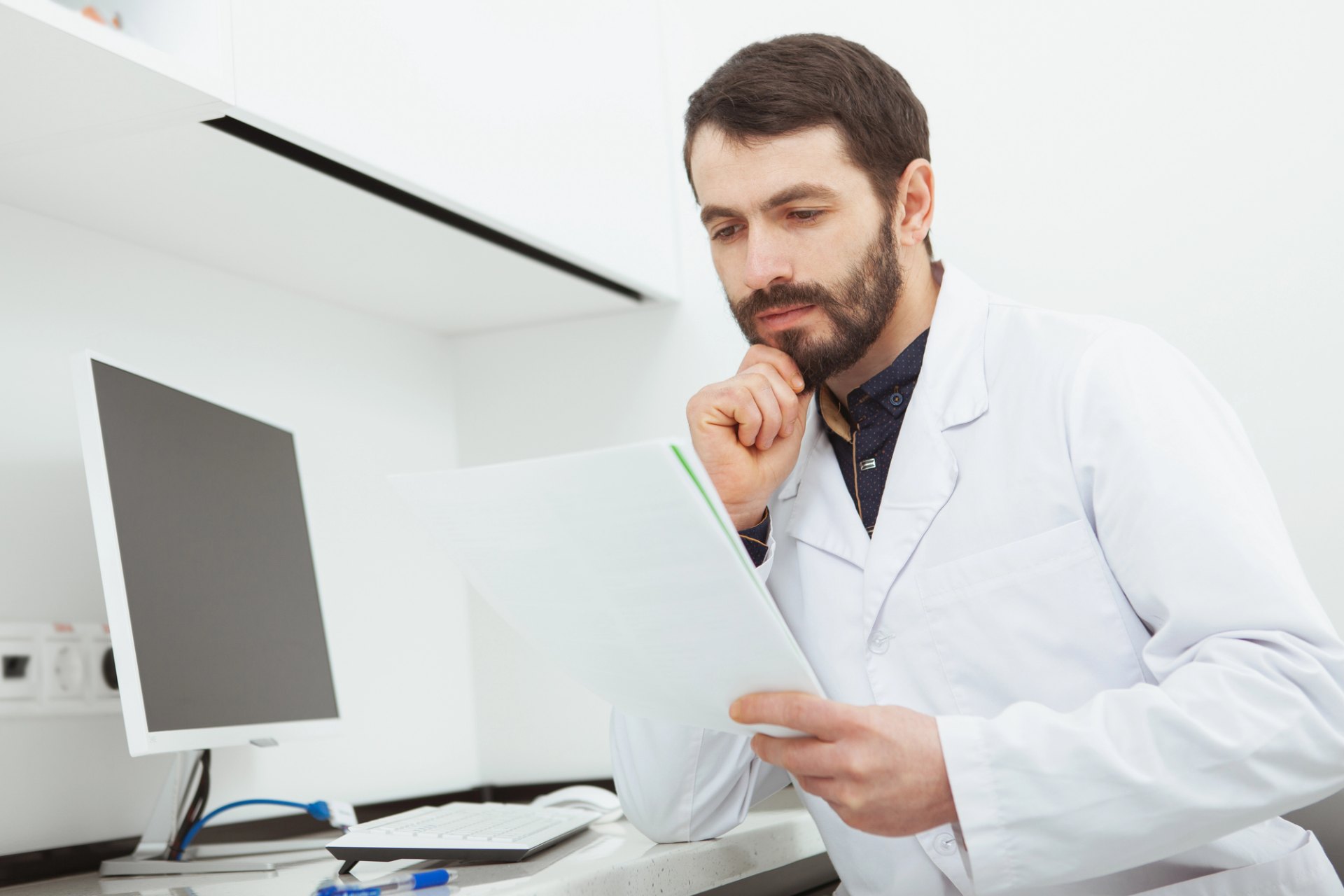Dentist reading clinical documents