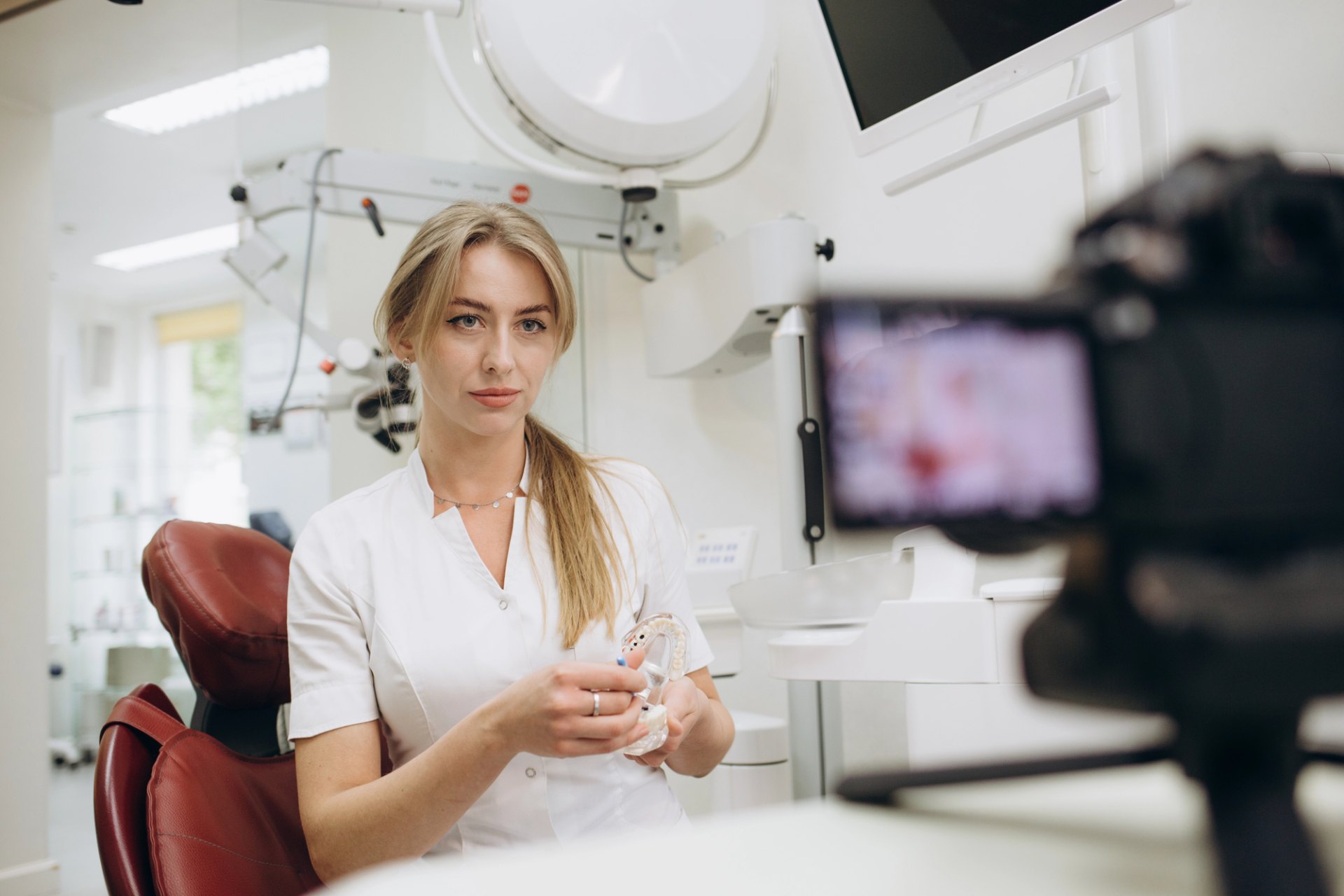 Dentist presenting to camera in a dental clinic